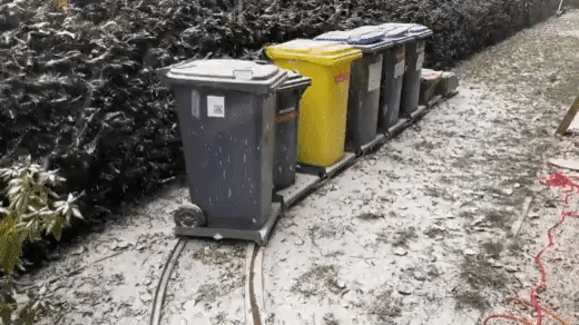 A chap has built a train track - for his trash bins.__https___t.co_8xPNh2nJuC.gif