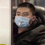 chinese-man-smoking-a-cigarette-through-hole-in-face-mask.jpg
