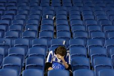 A-dejected-Brighton-Hove-Albion-fan-sits-alone-in-the-stands.jpg