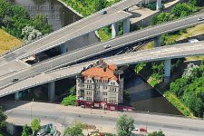 A049-00654_The_A100_motorway_is_built_around_a_1910_built_house_Rattenburg_Berlin_Germany_aerial.jpg