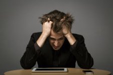 man-suffering-burn-out-sitting-his-desk-his-tablet-pc-his-head-bowed-hands-running-his-hair-3158.jpg