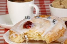 12750301-iced-danish-pastry-whirl-with-cup-of-coffee-and-sugar-cubes-Stock-Photo.jpg