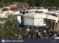 scrapyard-with-wheel-hubs-caravans-and-crushed-cars-sweden-DGHE21.jpg